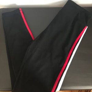 Black leggings with red and white stripes